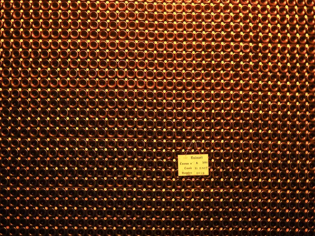 Bottles of Ruinart Champagne aging in a cellar in Reims