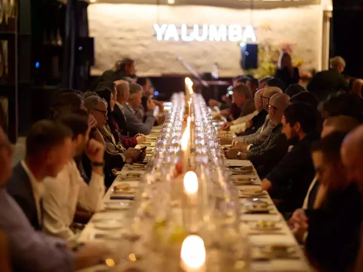 A table of people eating and drinking in the Yalumba cellars