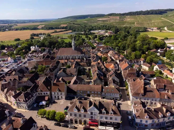 The village of Chablis with vines on hills in the background