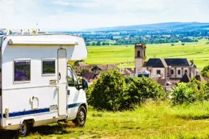 A campervan parked by Pommard village with a view of the church