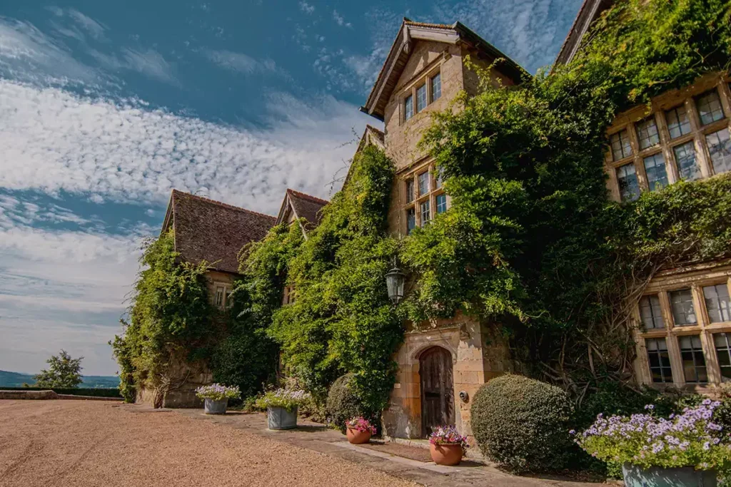 A big country house, Weyborne Estate, covered in ivy.