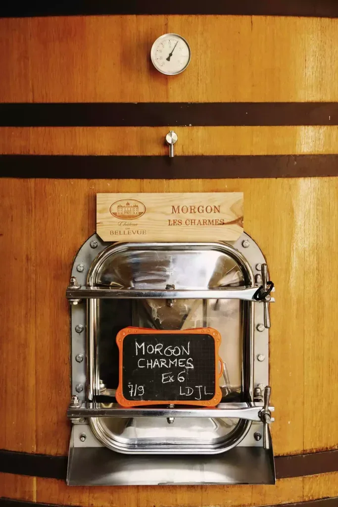 A close-up of a barrel with small chalkboard with Morgon Charmes written on it