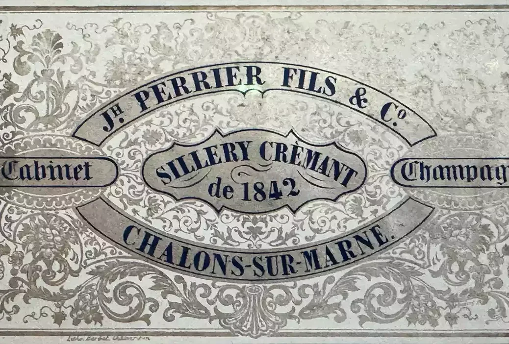 An old Joseph Perrier label with black letters on shiny silver patterned paper