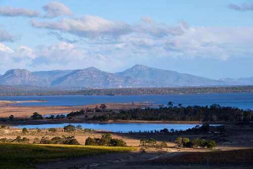 cool day view with some light cloud of mountains and a lagoon in Tasmania