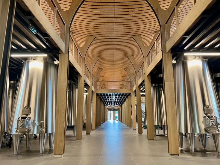 Shiny steel tanks and a spectacular wooden roof of a cellar at Château Cantemerle