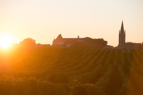 A sunset in St-Emilion, with a silhouette of the village's skyline