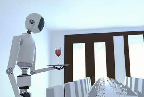 A white robot waiter holds a try with a glass of red wine above a boardroom type table with empty chairs and glasses